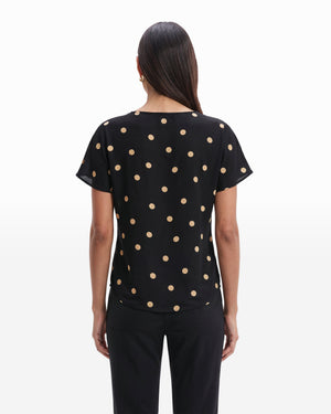 Black short sleeve blouse with large tan polka dots, bateau neckline, relaxed fit, shown from the back
