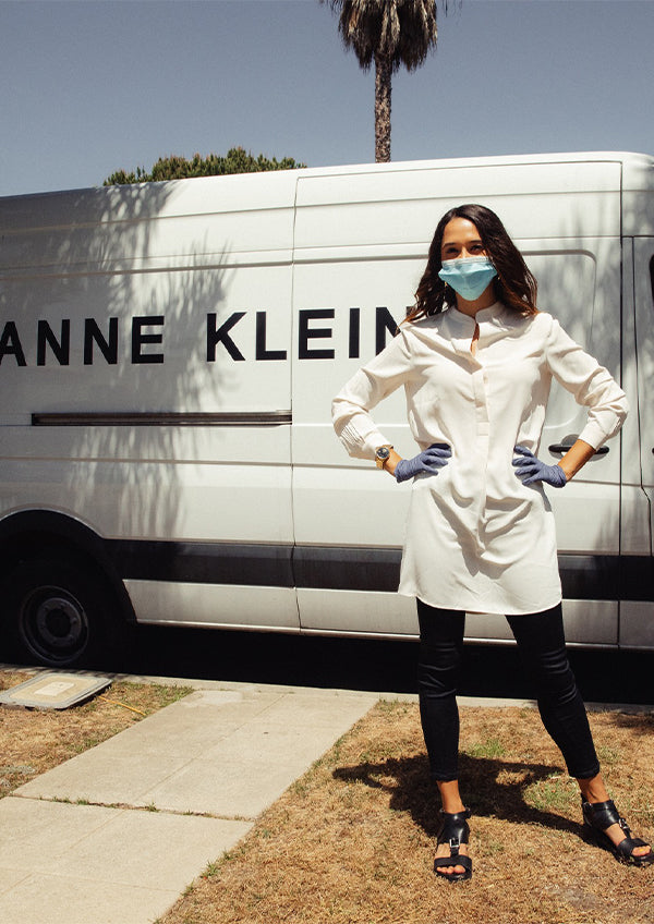 Anne Klein white button-up shirt on model with black leggings and sandals