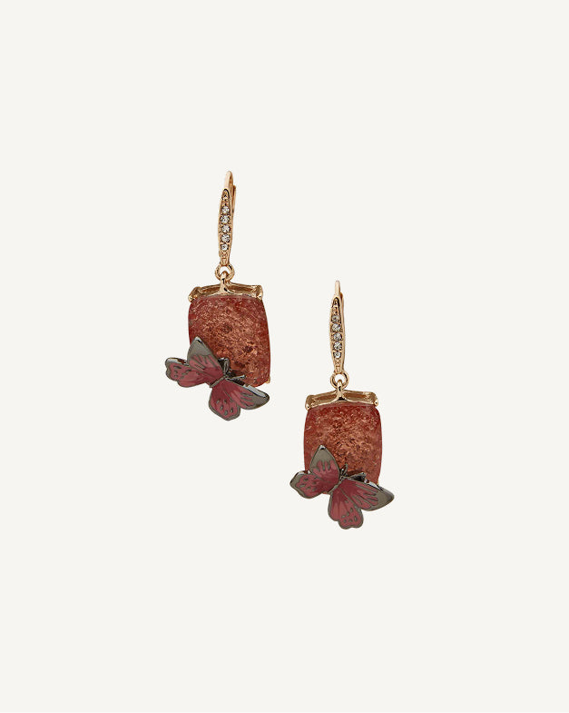 Product Coming Soon. Anne Klein drop earrings in gold tone featuring a terracotta stone with a red and grey butterfly charm and crystal pavé lever back
