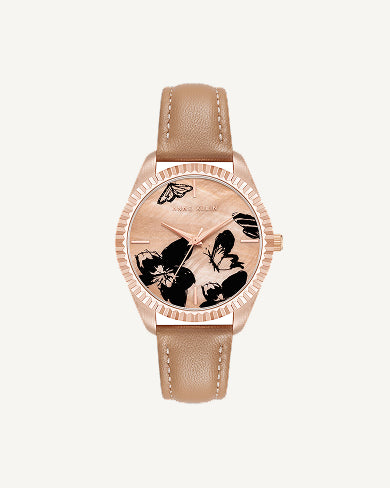 This petite watch draws its character from a butterfly motif on the dial, giving it a decorative quality that feels more like jewelry than a standard timepiece. The compact 16mm case sits delicately on the wrist, scaled for women who prefer their accessories fine and understated rather than oversized. A smooth leather strap in a classic buckle closure keeps the fit secure and adjustable, while the mineral crystal lens protects the dial from everyday scratches and scuffs. The proportions here are deliberately small, making this a watch that layers well alongside bracelets without competing for attention. Water resistant to 100 feet, it holds up to real life, not just careful occasions.