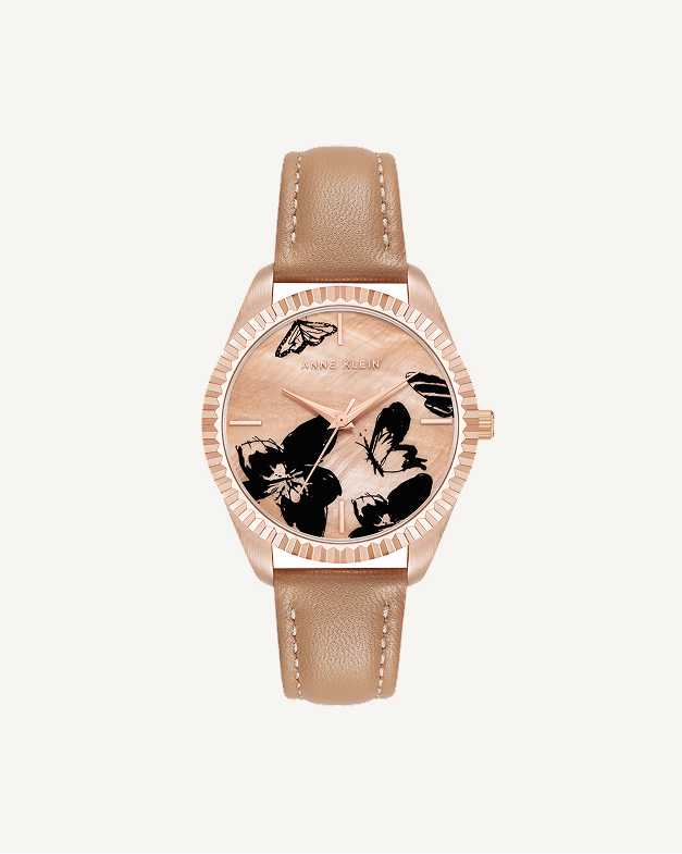 This petite watch draws its character from a butterfly motif on the dial, giving it a decorative quality that feels more like jewelry than a standard timepiece. The compact 16mm case sits delicately on the wrist, scaled for women who prefer their accessories fine and understated rather than oversized. A smooth leather strap in a classic buckle closure keeps the fit secure and adjustable, while the mineral crystal lens protects the dial from everyday scratches and scuffs. The proportions here are deliberately small, making this a watch that layers well alongside bracelets without competing for attention. Water resistant to 100 feet, it holds up to real life, not just careful occasions.