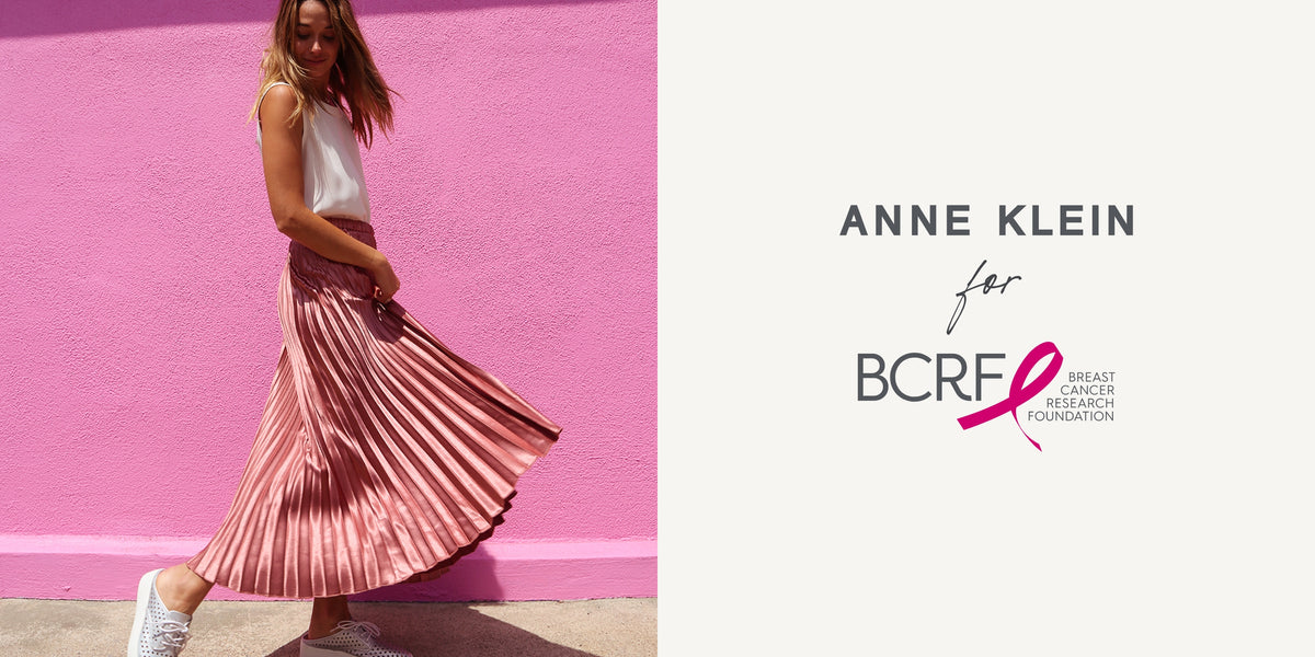 Anne Klein pleated mauve skirt on model with white sleeveless top against pink wall