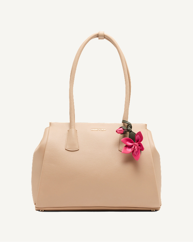Anne Klein structured tote bag in nude leather with double top handles and a pink floral charm accent