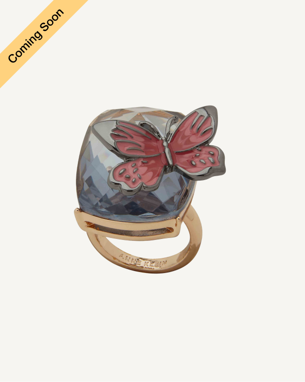 Product Coming Soon. Anne Klein cocktail ring in gold tone with a faceted blue stone and red butterfly charm overlay