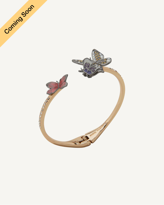 Product Coming Soon. Anne Klein open-cuff bangle bracelet in gold tone featuring two butterfly charms in blue and pink enamel