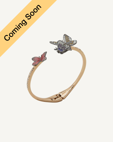 Product Coming Soon. Anne Klein open-cuff bangle bracelet in gold tone featuring two butterfly charms in blue and pink enamel