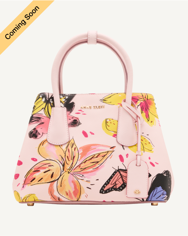 Product Coming Soon. Anne Klein mini structured satchel in pink with an illustrated butterfly and floral print, gold-tone hardware