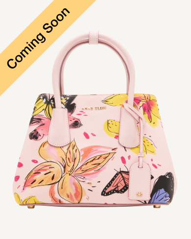 Product Coming Soon. Anne Klein mini structured satchel in pink with an illustrated butterfly and floral print, gold-tone hardware